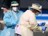 A medical worker administers a COVID-19 test at a testing clinic during a lockdown to curb the spread of a coronavirus disease (COVID-19) outbreak in Auckland, New Zealand, August 26, 2021. REUTERS/Fiona Goodall