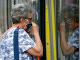 People wear face masks to protect against the coronavirus as they ride with public transport in Vienna, Austria, Wednesday, July 15, 2020. (AP Photo/Ronald Zak)