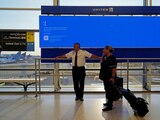 United Airlines employees wait by a departures monitor displaying a blue error screen, also known as the “Blue Screen of Death” inside Terminal C in Newark International Airport, after United Airlines and other airlines grounded flights due to a worldwide tech outage caused by an update to CrowdStrike's "Falcon Sensor" software which crashed Microsoft Windows systems, in Newark, New Jersey, U.S., July 19, 2024. REUTERS/Bing Guan TPX IMAGES OF THE DAY