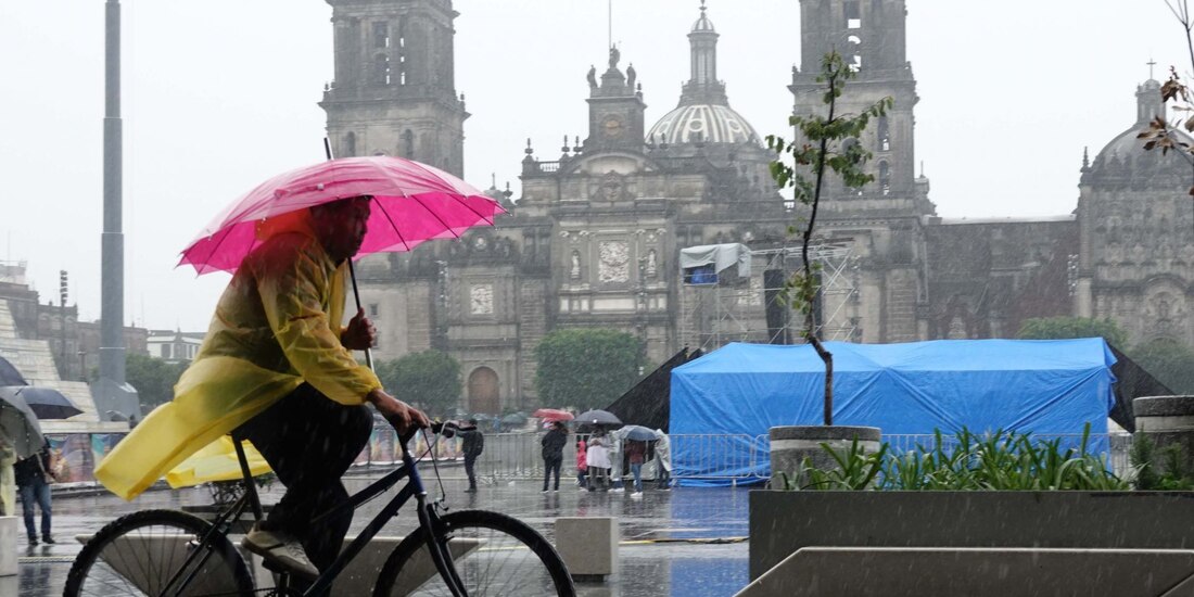Transeúntes se cubren de las fuertes lluvias presentadas en el Centro de la Ciudad de México.