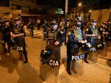 Police guard outside President Dina Boluarte's house during a raid ordered by the Attorney General's Office aimed at seizing luxury watches as part of a preliminary investigation into alleged illicit enrichment in Lima, Peru, Saturday, March 30, 2024. (AP Photo/Martin Mejia)