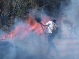 En la imagen de archivo, dos personas tratan de contener un incendio forestal