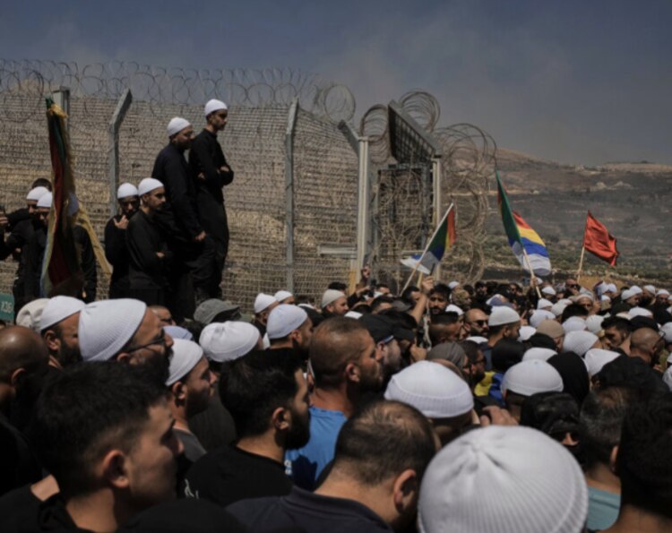 Miembros de la comunidad drusa israelí se reúnen en valla fronteriza que separa los Altos del Golán, controlados por Israel, de Siria.