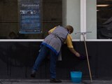 La imagen muestra a una mujer que realiza labores de limpieza