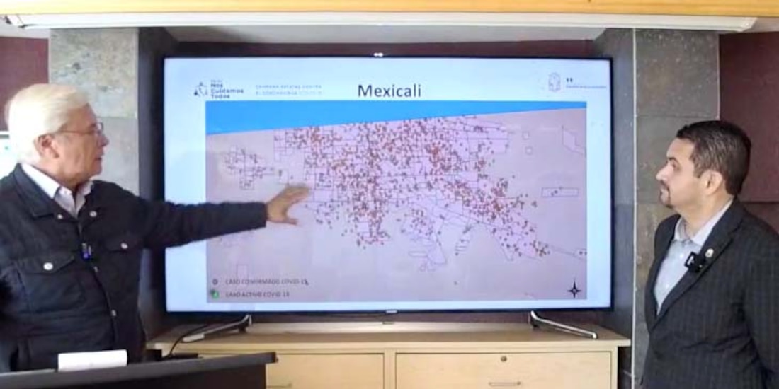 El gobernador Jaime Bonilla (izq.) y el secretario de salud, Alonso Pérez Rico, analizan la distribución de casos activos en Mexicali.