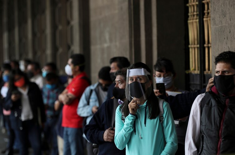 Personas portan cubrebocas y protectores a causa de la pandemia del nuevo coronavirus, en la Ciudad de México, e 1 de junio de 2020.