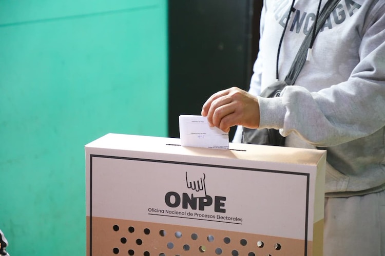 Una persona emite su voto en una urna, en la segunda vuelta electoral de Perú.