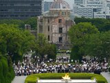 Visitors observe a minute of silence for the victims of the atomic bombing, at 8:15am, the time atomic bomb exploded over the city, at the Hiroshima Peace Memorial Park during the ceremony to mark the 75th anniversary of the bombing Thursday, Aug. 6, 2020, in Hiroshima, western Japan. (AP Photo/Eugene Hoshiko)