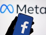 A smartphone with Facebook's logo is seen in front of displayed Facebook's new rebrand logo Meta in this illustration taken October 28, 2021. REUTERS/Dado Ruvic/Illustration