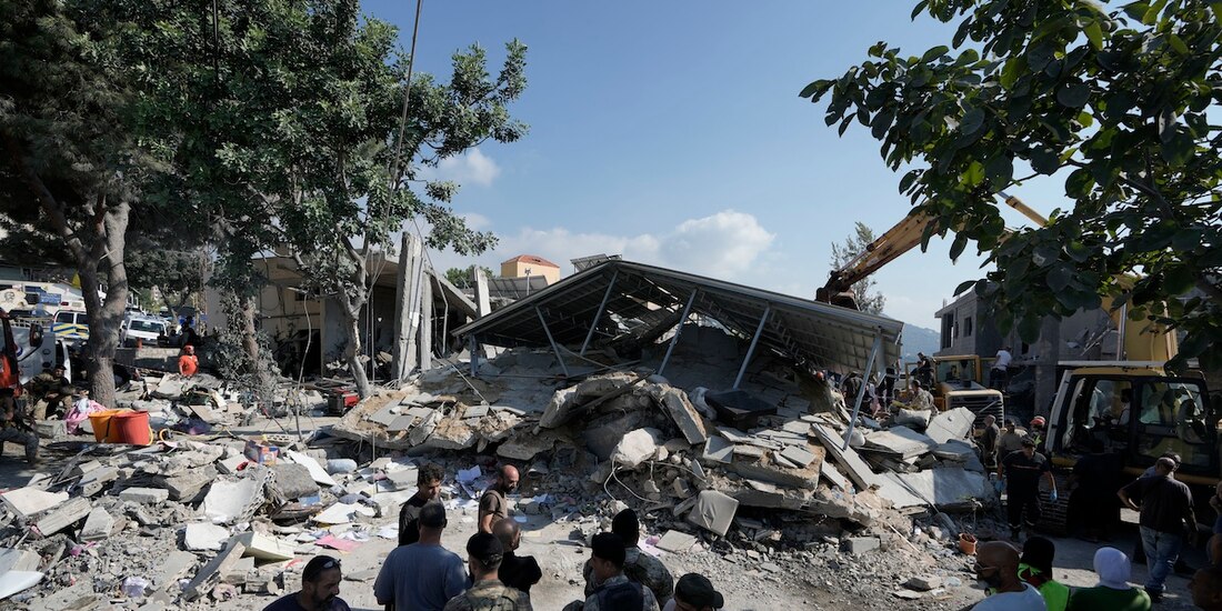 Fuerzas militares y civiles muestran los daños de un nuevo impacto al norte de Beirut, ayer.