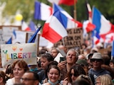 Protesters attend a demonstration against France's restrictions, including a compulsory health pass, to fight the coronavirus disease (COVID-19) outbreak, in Paris, France, August 21, 2021. REUTERS/Christian Hartmann