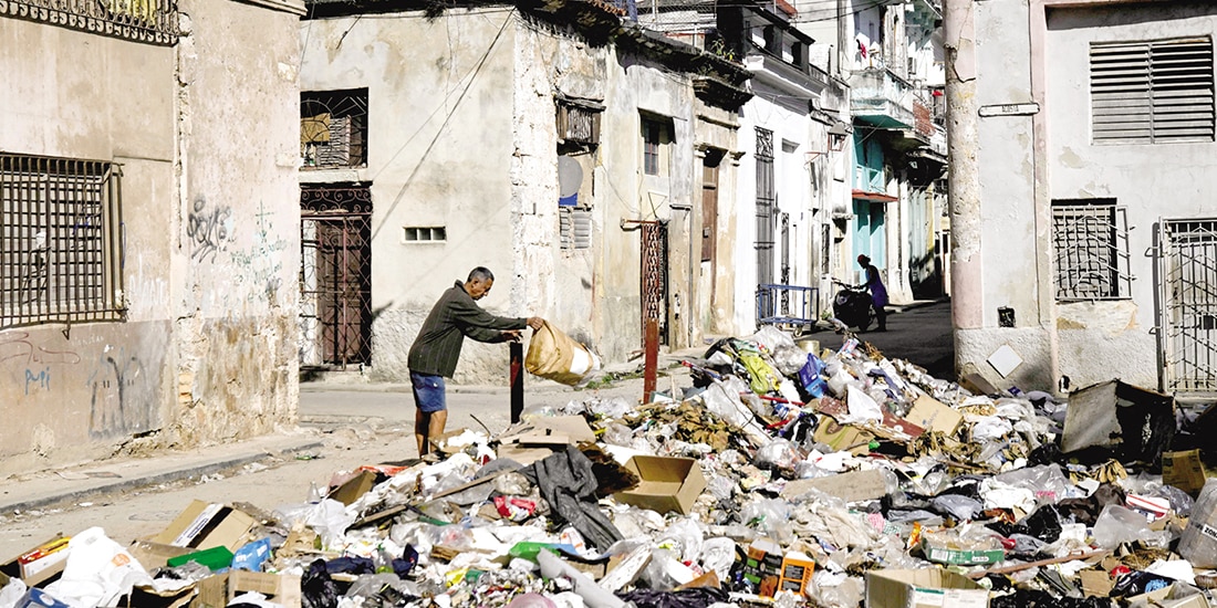 Un hombre tira basura en una calle del centro de La Habana, ayer.