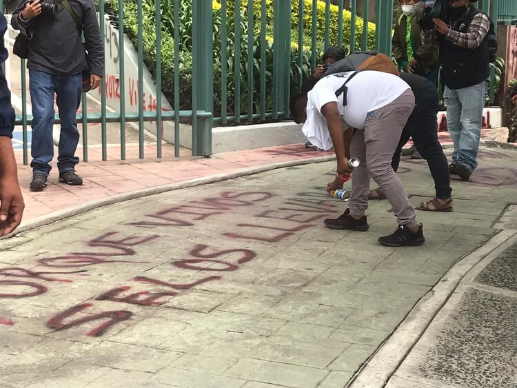 Un normalista pinta banqueta en inmediaciones del CJF.