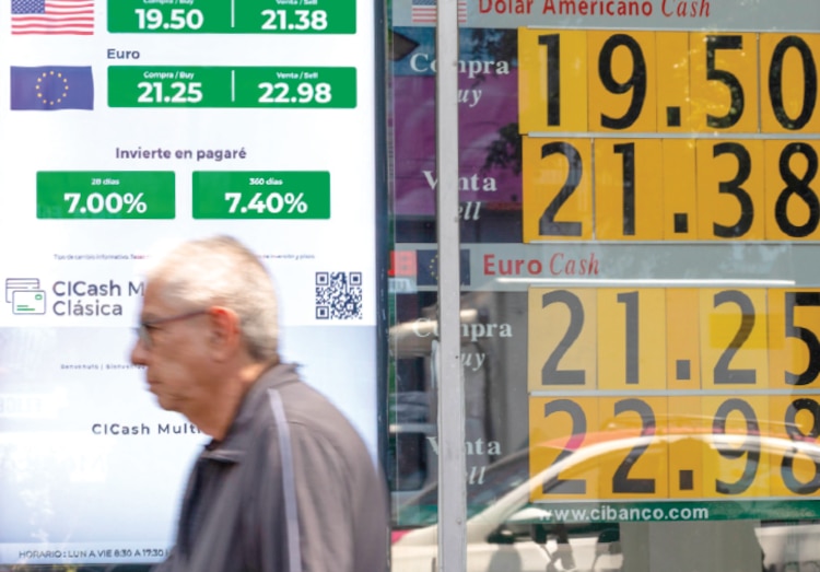 Un hombre mayor camina frente a un
banco ubicado en la CDMX, en junio