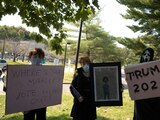 A family holding placards protests outside of the Walter Reed National Military Medical Center, where U.S. President Donald Trump is being treated for coronavirus disease (COVID-19) in Bethesda, Maryland, U.S. October 4, 2020. REUTERS/Cheriss May