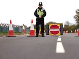 Un policía bloquea una carretera cerca de la base aérea RAF Fairford, que alberga la Fuerza Aérea de EU, en GB, ayer.