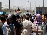 Crowds of people show their documents to U.S. troops outside the airport in Kabul, Afghanistan August 26, 2021. REUTERS/Stringer NO RESALES. NO ARCHIVES