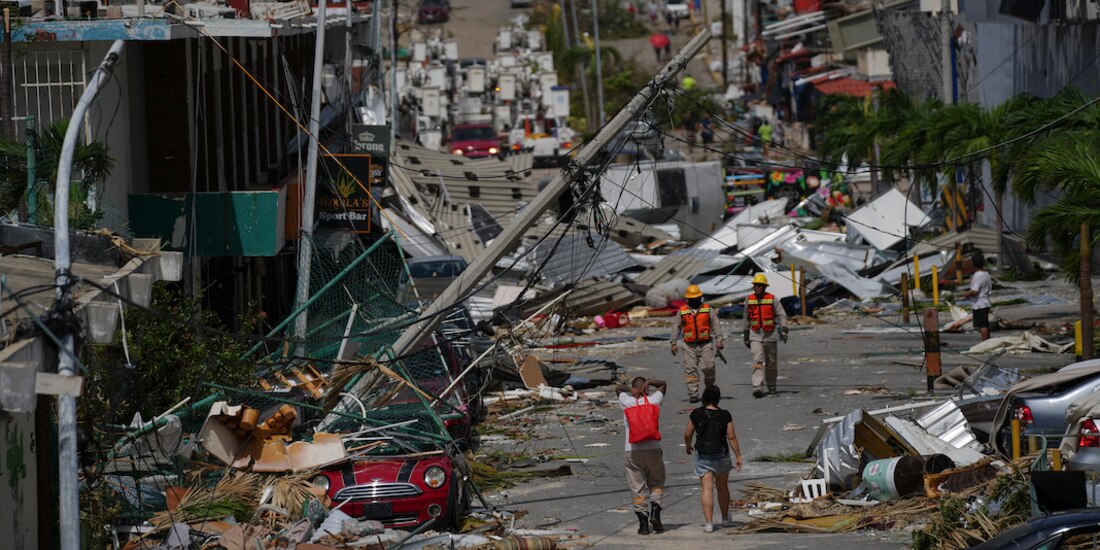 Trabajadores caminan por una calle del puerto de Acapulco, ayer.