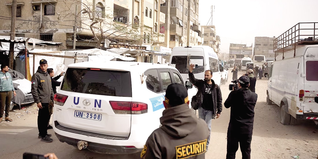Un vehículo de la ONU escolta un autobús con pacientes, ayer.
