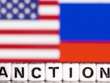 Imagen ilustrativa con la bandera de EU y la palabra "sanciones" en inglés.