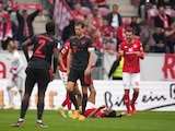 Mainz players celebrate at the final whistle as Bayern's Leon Goretzka leaves the pitch dejected after the German Bundesliga soccer match between 1. FSV Mainz 05 and FC Bayern Munich at the Mewa Arena in Mainz, Germany, Saturday, April 22, 2023. (AP Photo/Matthias Schrader)