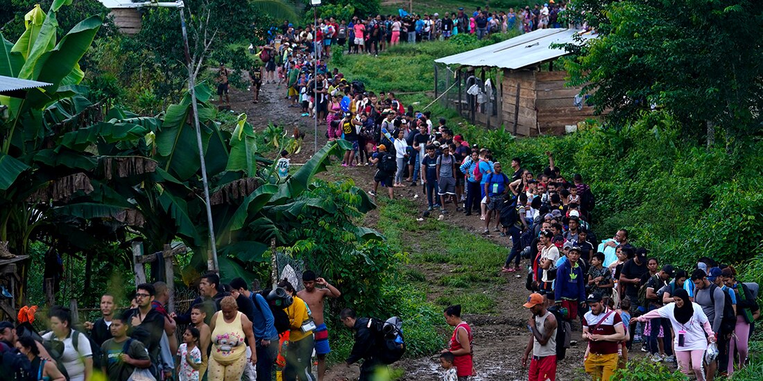 Migrantes que buscan llegar a Estados Unidos hacen fila para tomar un bote en Bajo Chiquito, en la provincia de Darién en Panamá