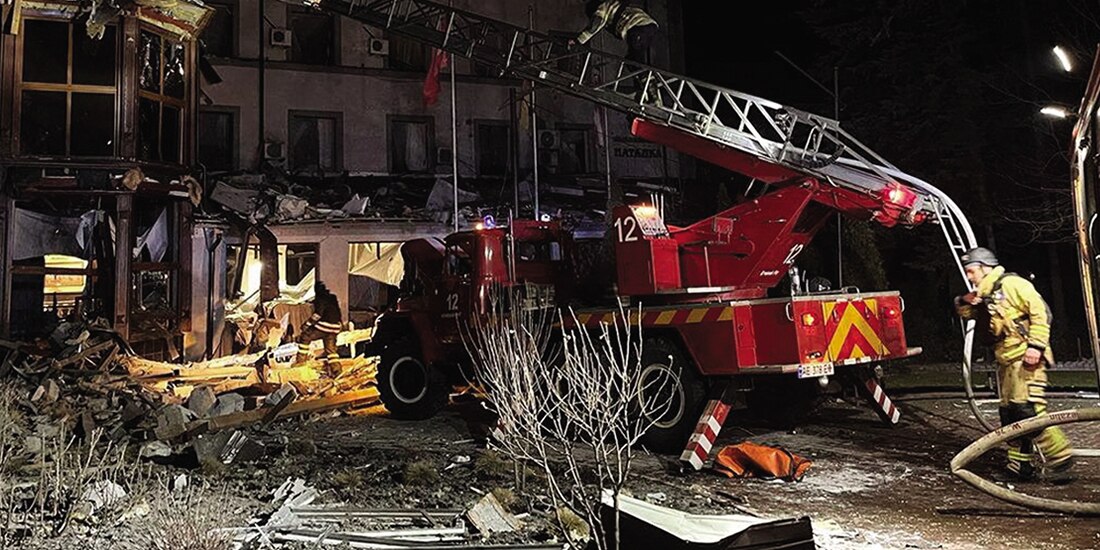 Bomberos y personal de emergencias intentan ingresar al inmueble sacudido por un ataque rival, ayer, en Krivói Rog.