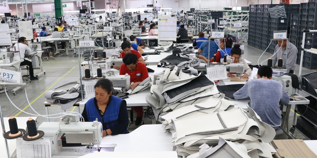 Personas trabajando en una maquiladora, en una fotografía ilustrativa.