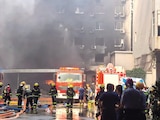 Personal de emergencia trabaja para controlar el fuego en una fábrica, ayer.