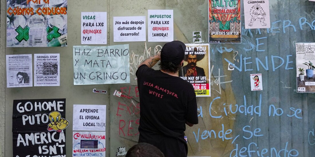 Un hombre coloca en una pared un mensaje de protesta, el pasado viernes.