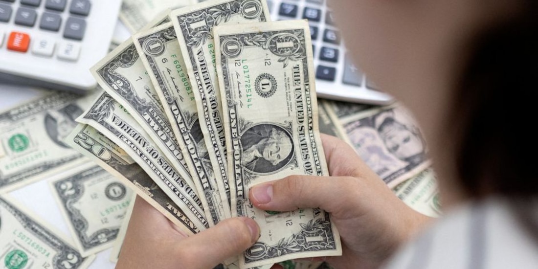 Una persona sostiene algunos billetes