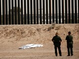 U.S. Border Patrol agents observe the body of a person covered in a white sheet near the border wall in El Paso, Texas, U.S., as seen from Ciudad Juarez, Mexico June 11, 2021. REUTERS/Jose Luis Gonzalez TPX IMAGES OF THE DAY