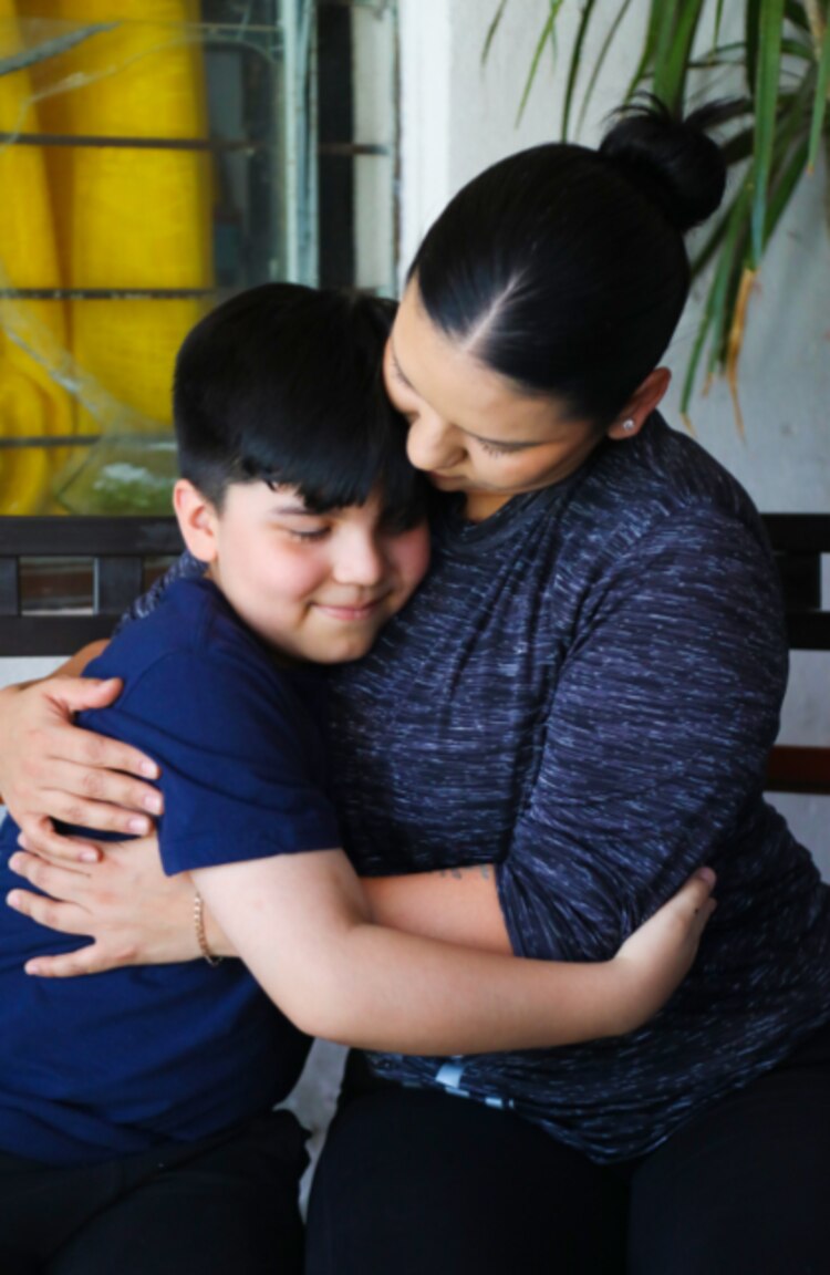 Madre e hijo se abrazan luego de que el menor venció el cáncer