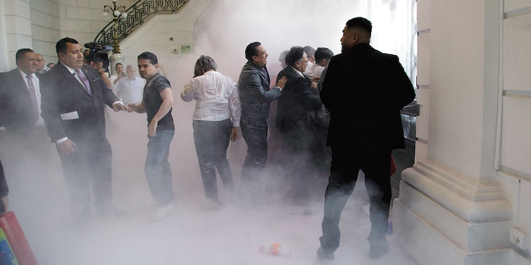 Personal de resguardo activa los extintores para dispersar a manifestantes, ayer.