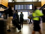 FILE PHOTO: Travellers check a departures list at the ticketing level of Seattle-Tacoma International Airport before the Thanksgiving holiday in Seattle, Washington, U.S. November 24, 2021. REUTERS/Lindsey Wasson/File Photo/File Photo