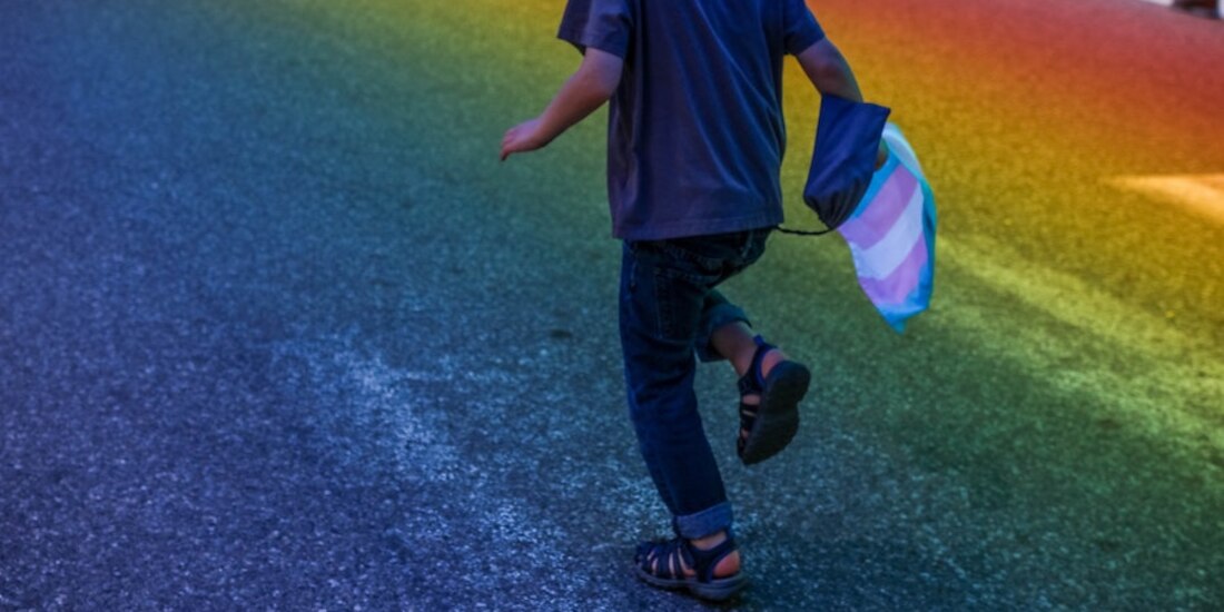 En la imagen de archivo, un pequeño porta la bandera del orgullo trans.
