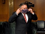 Secretary of State Mike Pompeo puts on a mask after a Senate Foreign Relations committee hearing on the State Department's 2021 budget on Capitol Hill Thursday, July 30, 2020, in Washington (Greg Nash/Pool via AP)