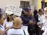 Policía habla con familiares de presos políticos durante una protesta, el 23 de enero.