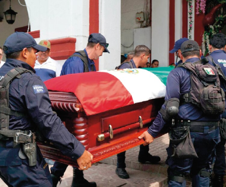 Familiares, amigos y autoridades locales despiden a la alcaldesa de Tepalcatepec, Michoacán, Martha Laura Mendoza y a su esposo, el jueves.