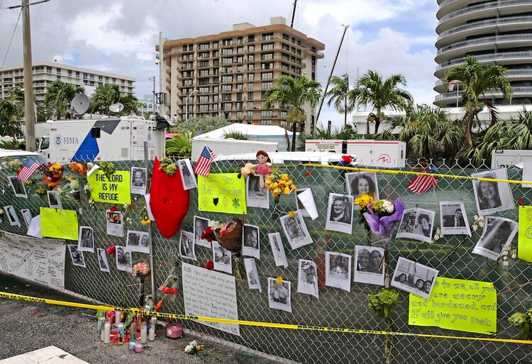 Familiares y amigos colocan fotografías de las víctimas cerca del inmueble afectado.