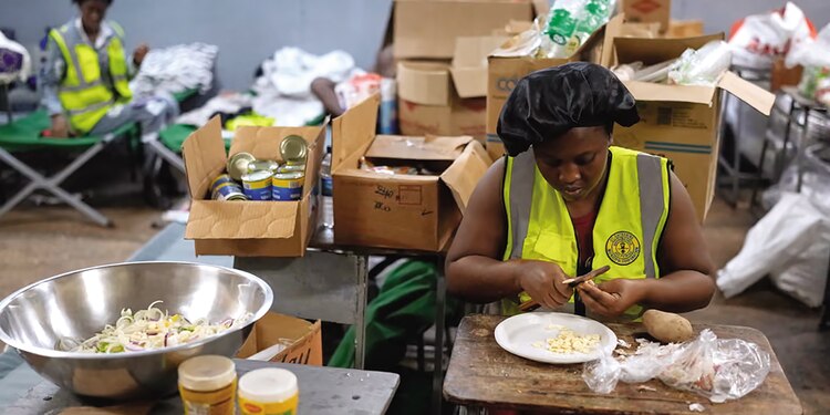 Cocineros preparan comidas en un albergue instalado en una escuela en Jamaica, ayer.