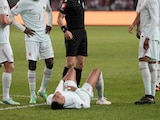 Kylian Mbappé tirado en el césped tras lesionarse.