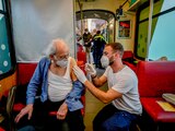 Personal sanitario vacuna a pasajeros en un tren, en Alemania.